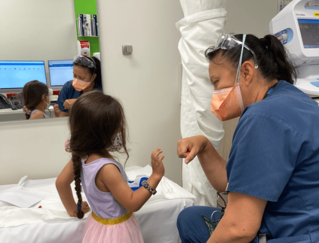 Child and doctor doing a fist bump